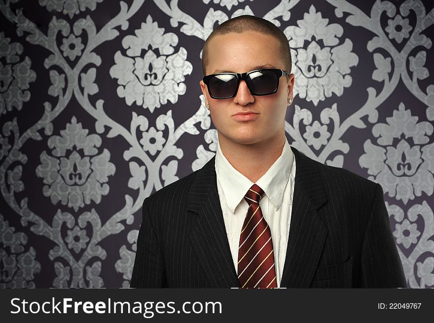 А classical style dressed man in sunglasses. А classical style dressed man in sunglasses