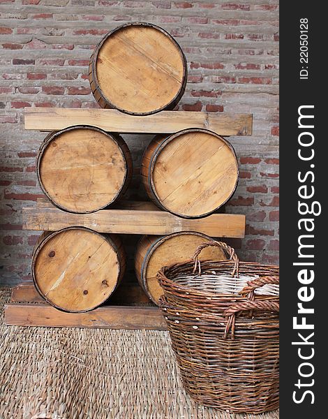 Wooden barrels and straw basket on mat