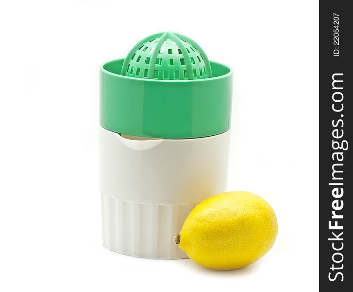 Green juicer and one lemon on white background