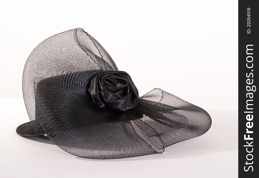 Small black stylish hat with grid flower