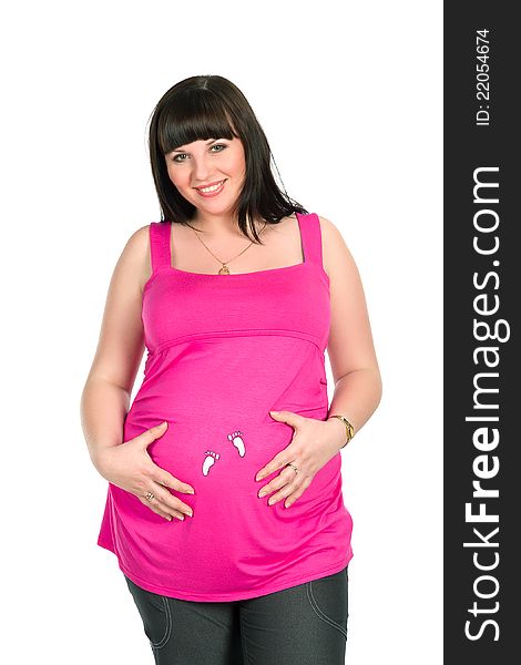 Pretty black-haired  pregnant woman wearing bright pink dress with baby's footprints. Pretty black-haired  pregnant woman wearing bright pink dress with baby's footprints