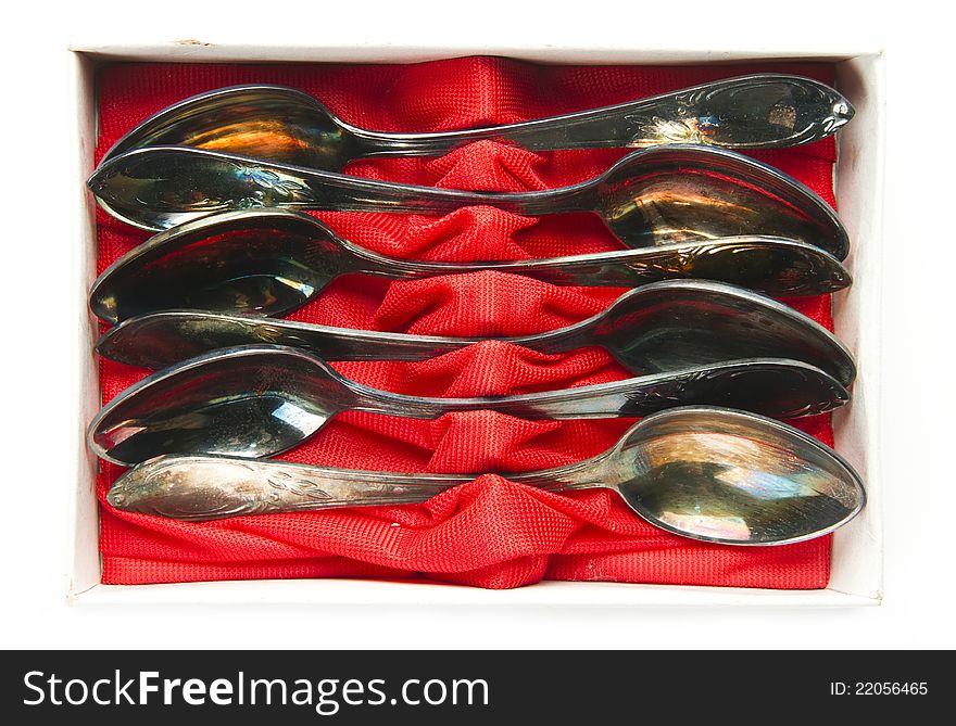 Old patina group of teaspoons in box isolated on white background. Old patina group of teaspoons in box isolated on white background