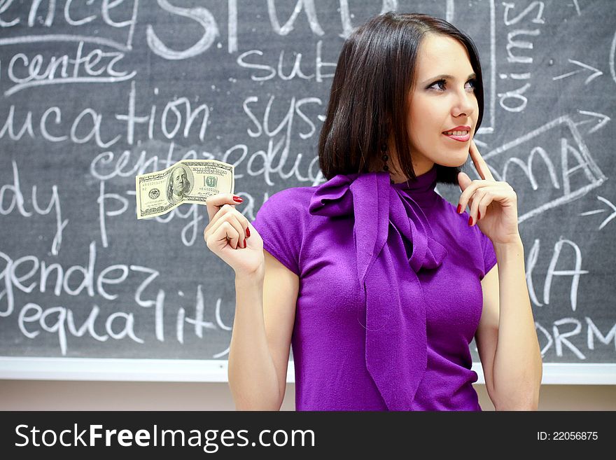 Caucasian woman with dollar note thinking