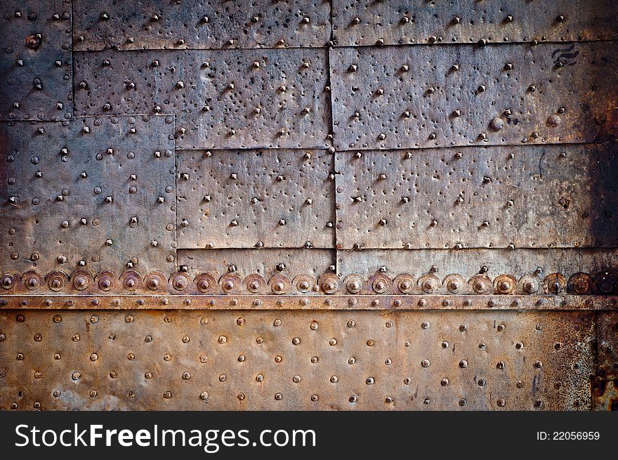 Rivets and ornament on old rusty metal door. Rivets and ornament on old rusty metal door