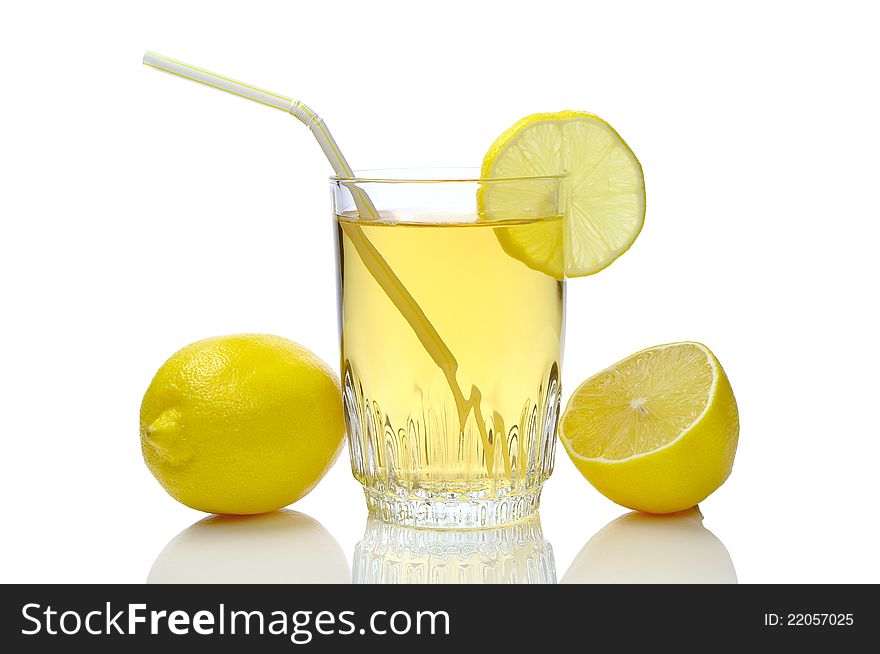 Glass of juice and lemons on a white background