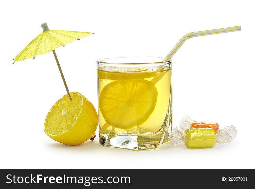 Glass of juice with lemons on a white background