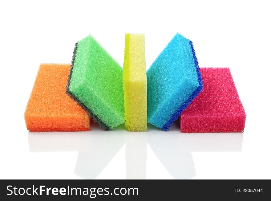 Five multi-colorful kitchen sponges for ware washing on a white background