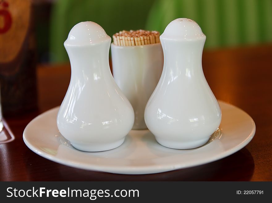 White condiment bottles on the table. White condiment bottles on the table