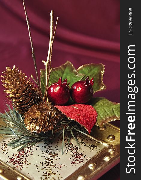 Christmas arrangement with cones, twigs and berries on the plate