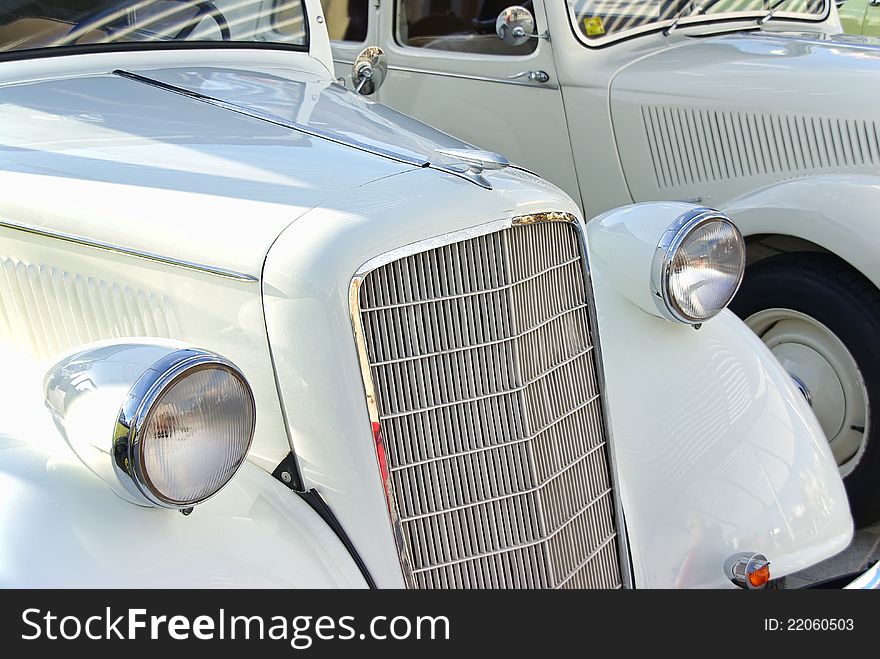 Details of two Classical white cars