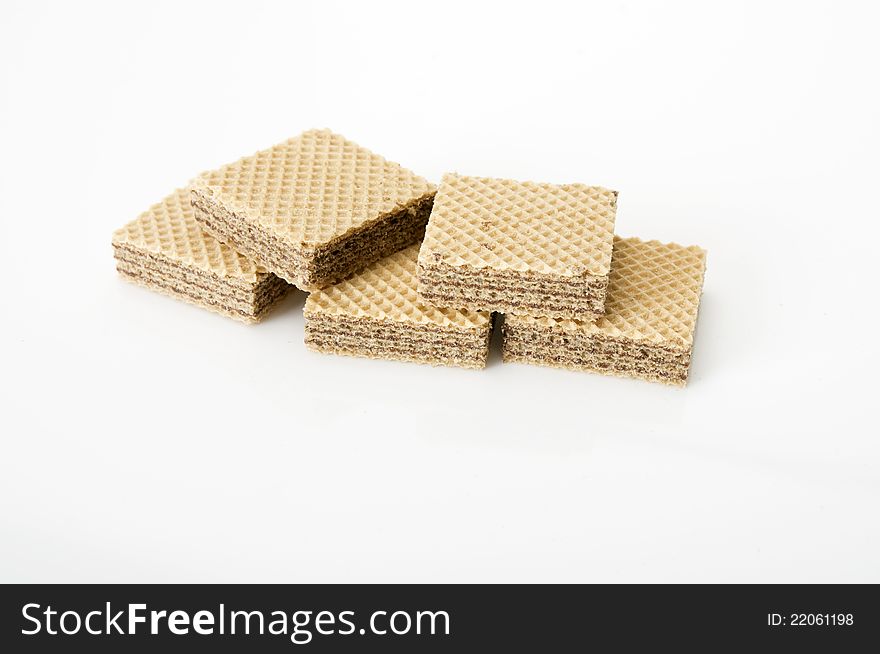 Chocolate wafer stacked over white background. Shot in the studio