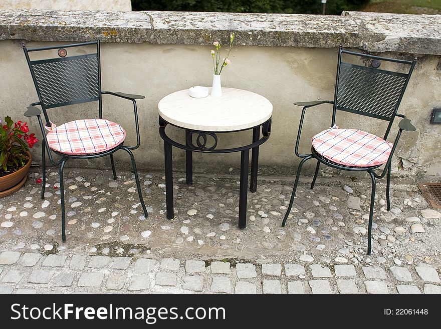 Two empty chairs and small table with decoration. Two empty chairs and small table with decoration.
