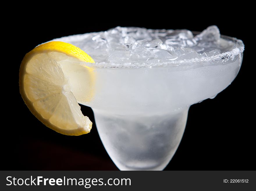 Margarita cocktail on ice with lemon slice