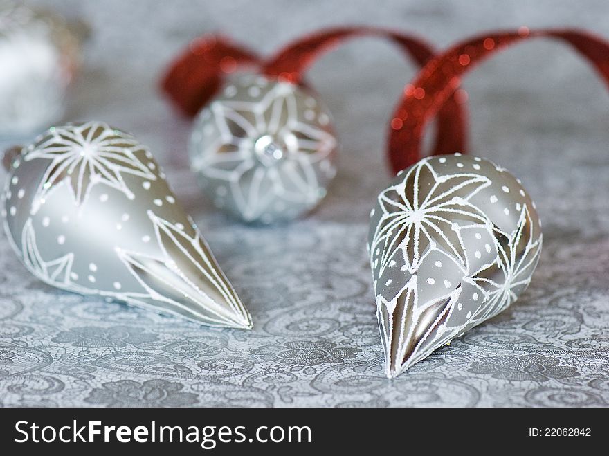 Beautiful silver glass christmas ornaments and red ribbon. Beautiful silver glass christmas ornaments and red ribbon