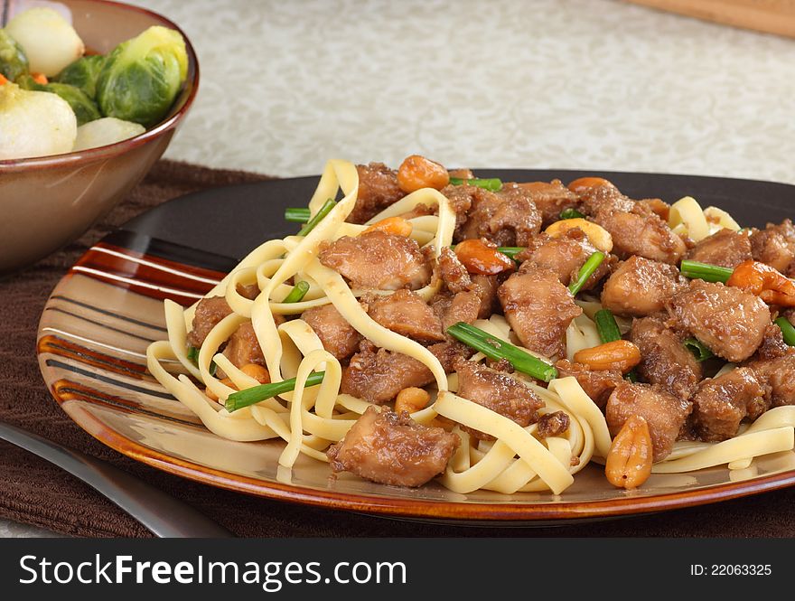 Chicken cashew with noodles on a dinner plate. Chicken cashew with noodles on a dinner plate