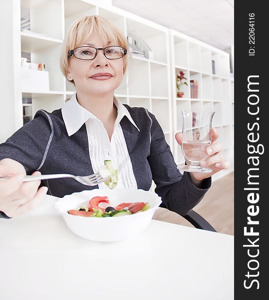 Adult Blonde Woman In Glasses Eats Salad