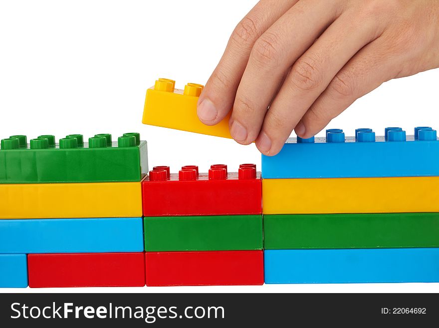 Close up of child toy bricks construction isolated on white background