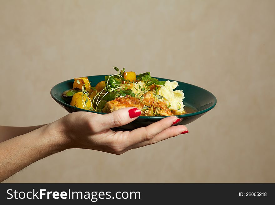 Woman holding a plate of delicious meal