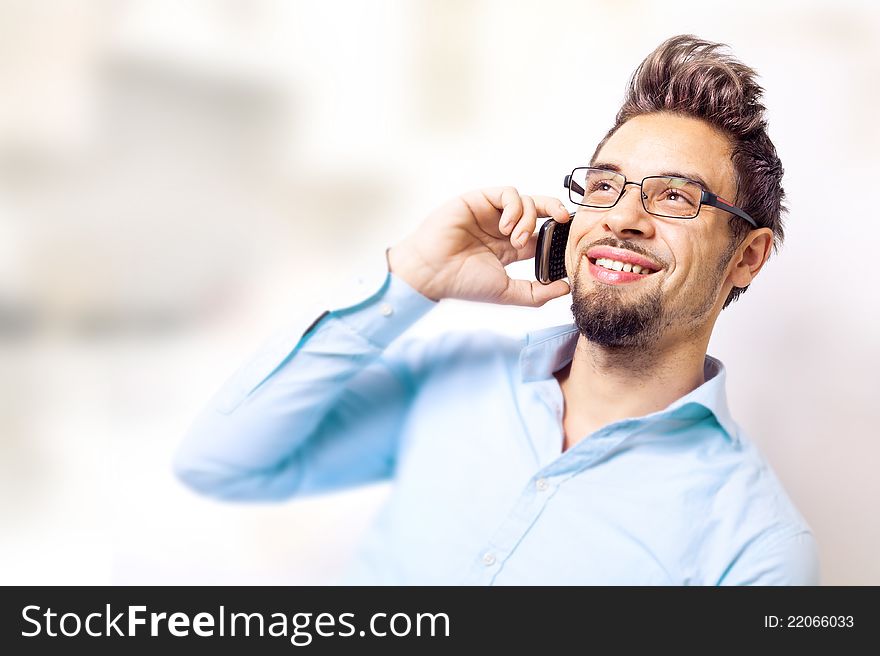 Handsome young man talking on cell