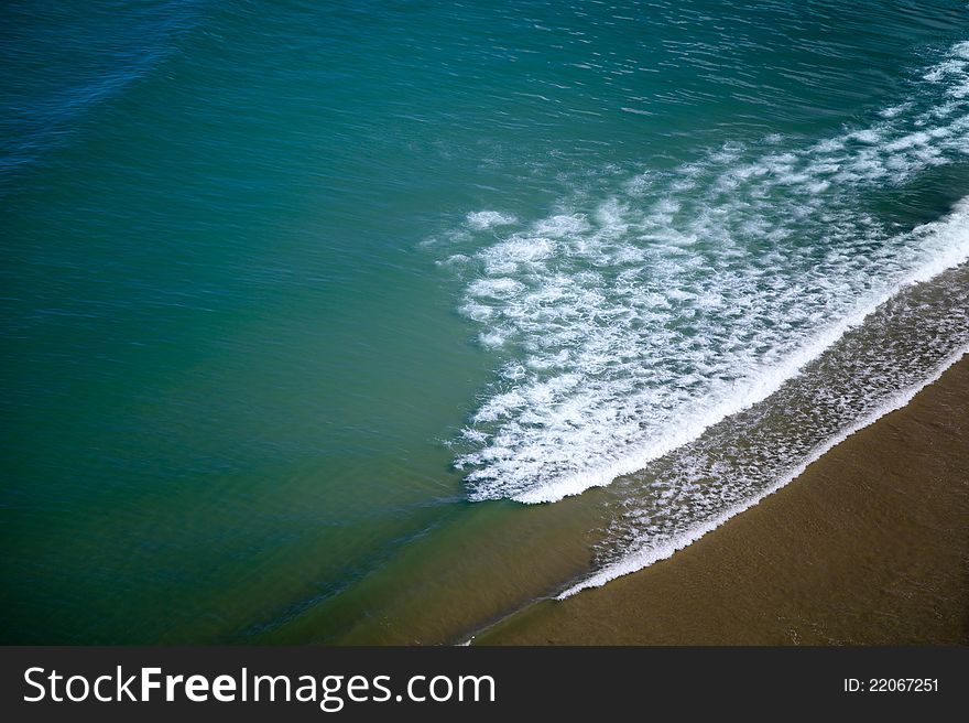 Cool blue color of ocean with few waves and send. Cool blue color of ocean with few waves and send