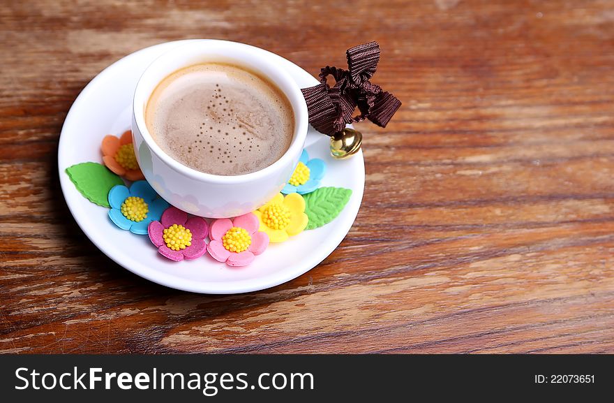 Cup of coffee on the wooden background. Cup of coffee on the wooden background