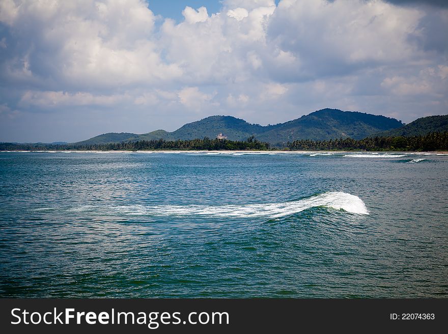 Beautiful view of water waves, clouds and mountain like beach. Beautiful view of water waves, clouds and mountain like beach