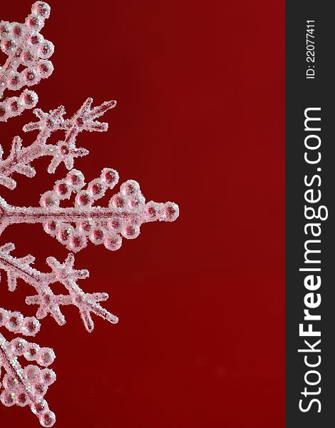 A glittering Christmas Snow Flake against a red back ground. A glittering Christmas Snow Flake against a red back ground.