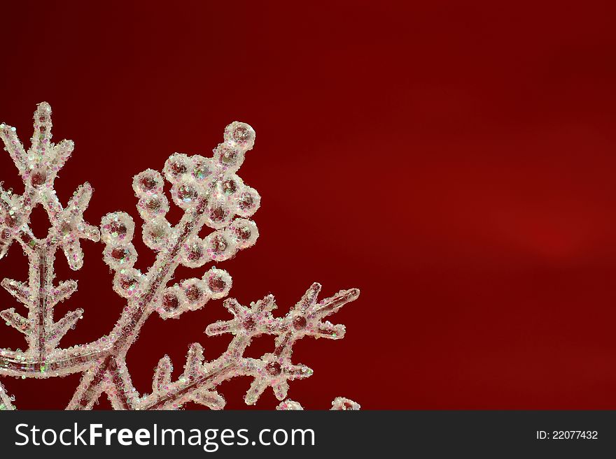 A glittering Christmas Snow Flake against a red back ground. A glittering Christmas Snow Flake against a red back ground.