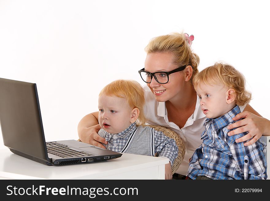 Baby Sitter with two children looking at laptop. Baby Sitter with two children looking at laptop
