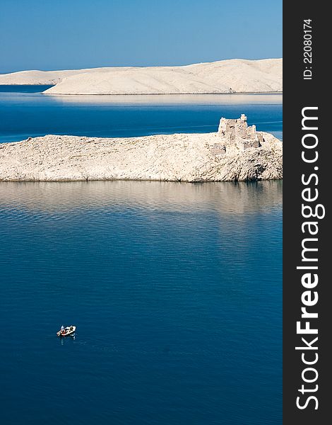 Alone boat, lighthouse and ruins on island pag in croatia. Alone boat, lighthouse and ruins on island pag in croatia
