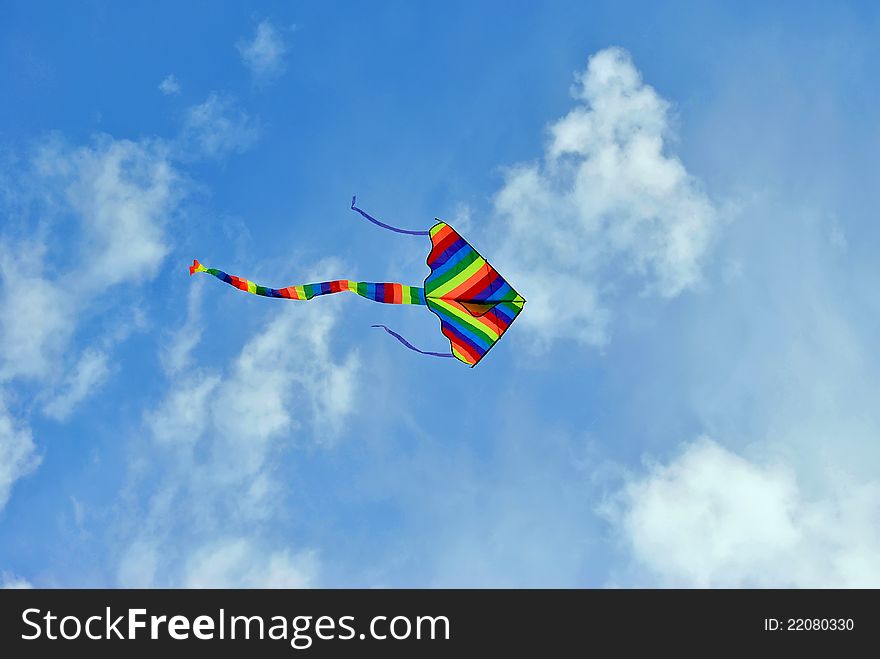 Flying colorful kite in the blue sky. Flying colorful kite in the blue sky