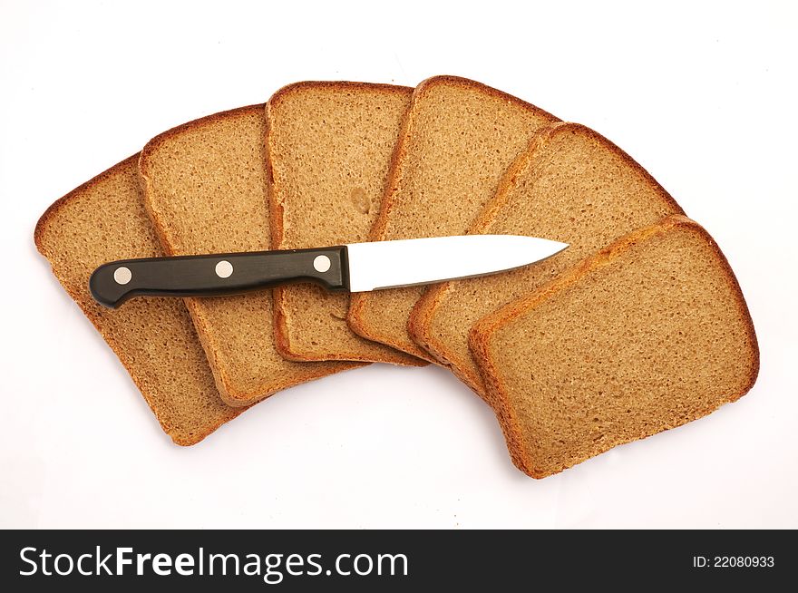 Cut bread with a knife on a white background
