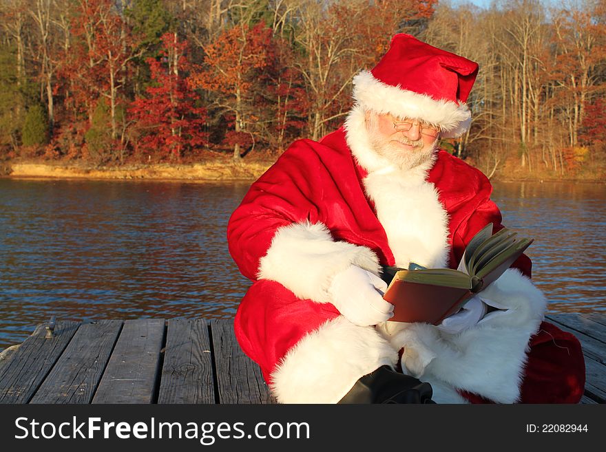 Santa Reading On The Dock
