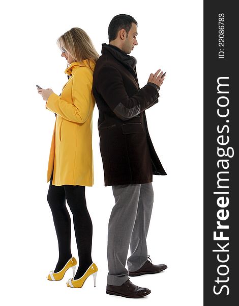 Man and women checking their cellular phones for messages. Man and women checking their cellular phones for messages