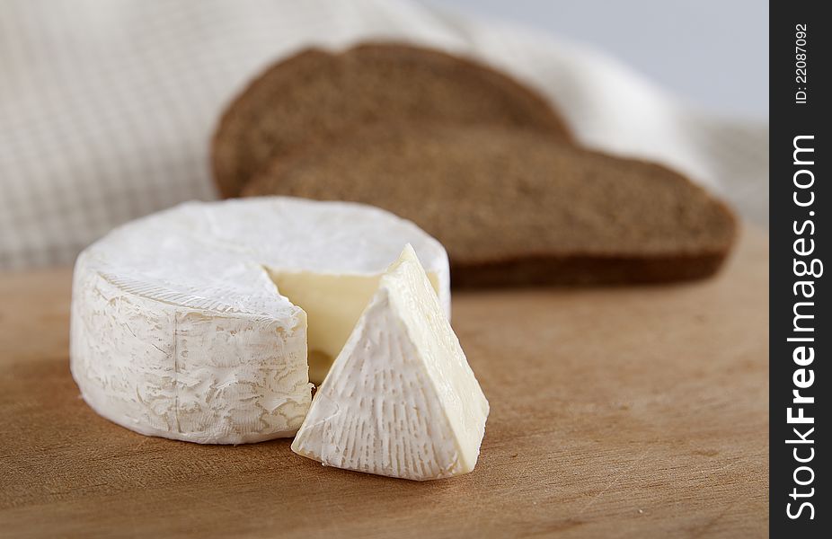 Pieces of camembert cheese on the wood board