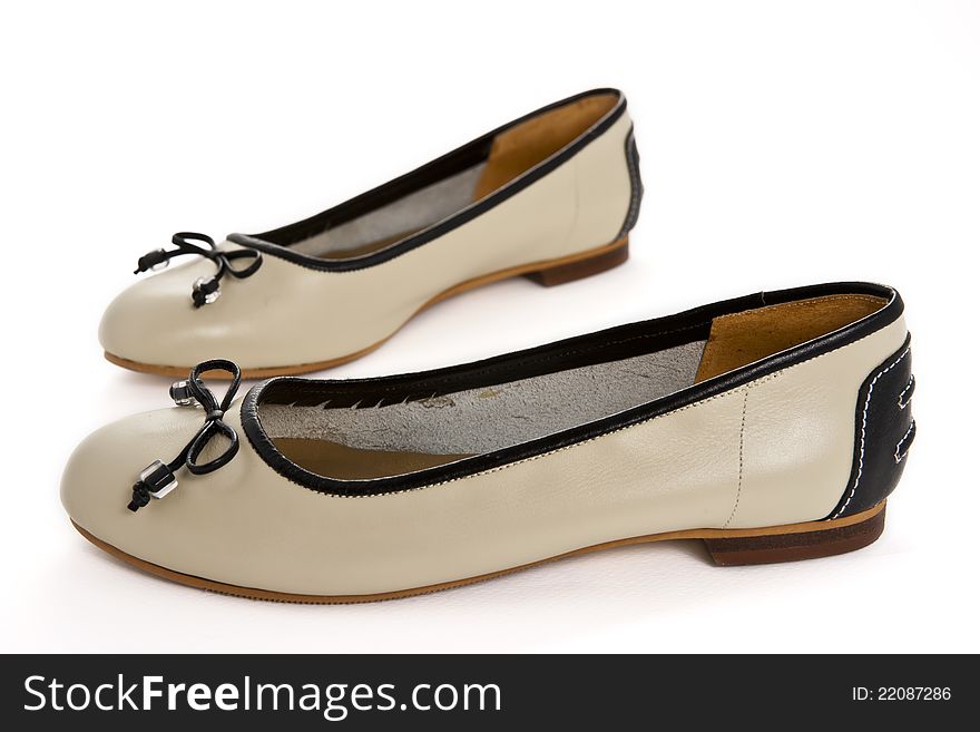 Pair Of Beige Female Shoes With Black Bow