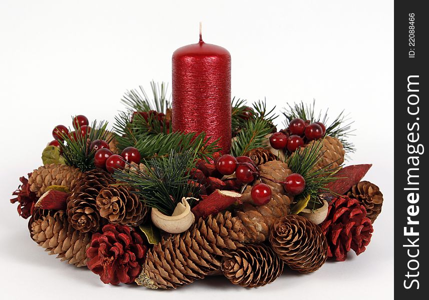 Red candle with the twigs of the spruce and cones. Red candle with the twigs of the spruce and cones