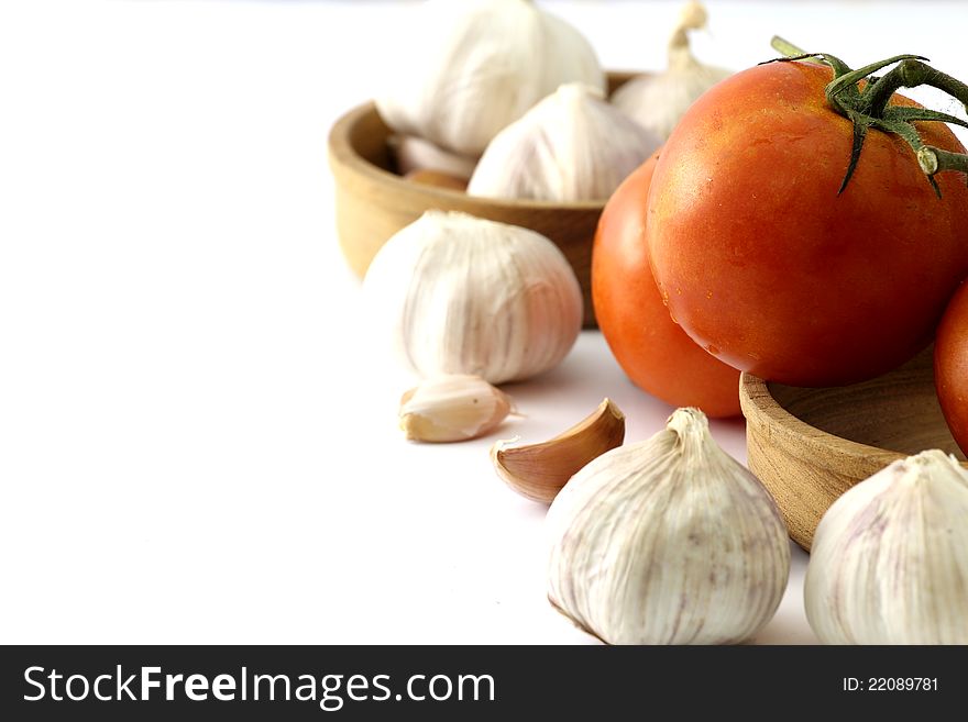 Tomatoes and garlic close up on white background