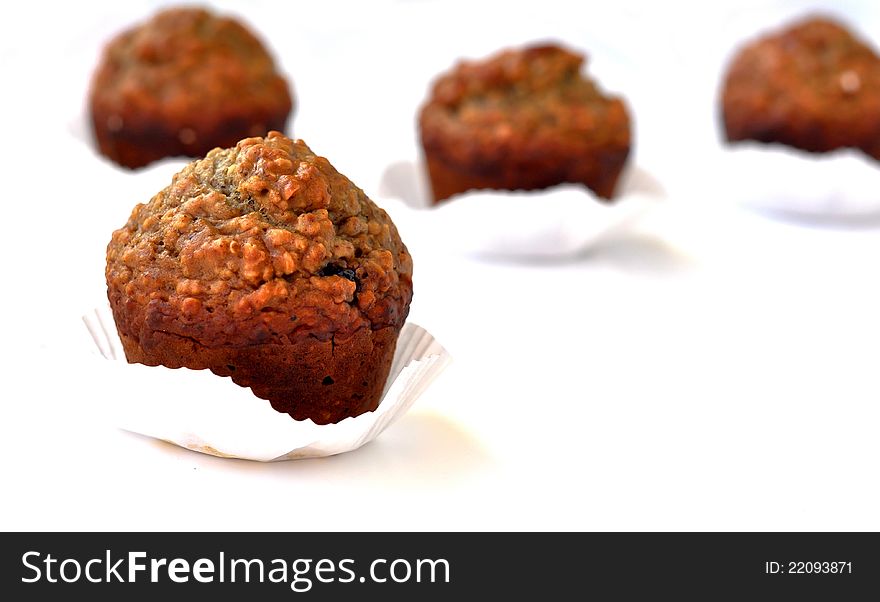 Brown muffins rich in nuts and cacao as shown in their textured outer layer. Brown muffins rich in nuts and cacao as shown in their textured outer layer