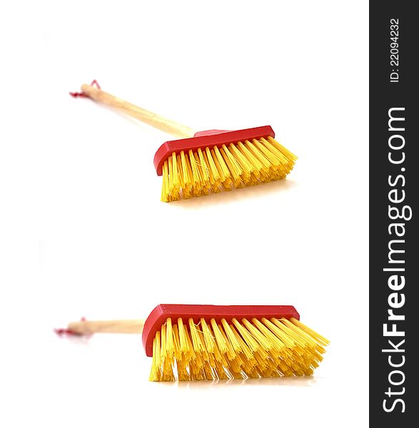 A small mop that is made exclusively for children to play with as a toy. A small mop that is made exclusively for children to play with as a toy