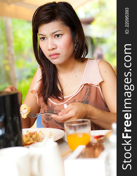 A girl look serious during her food