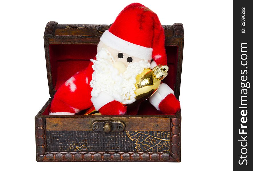 Toy santa klaus in an antiquarian chest on a white background