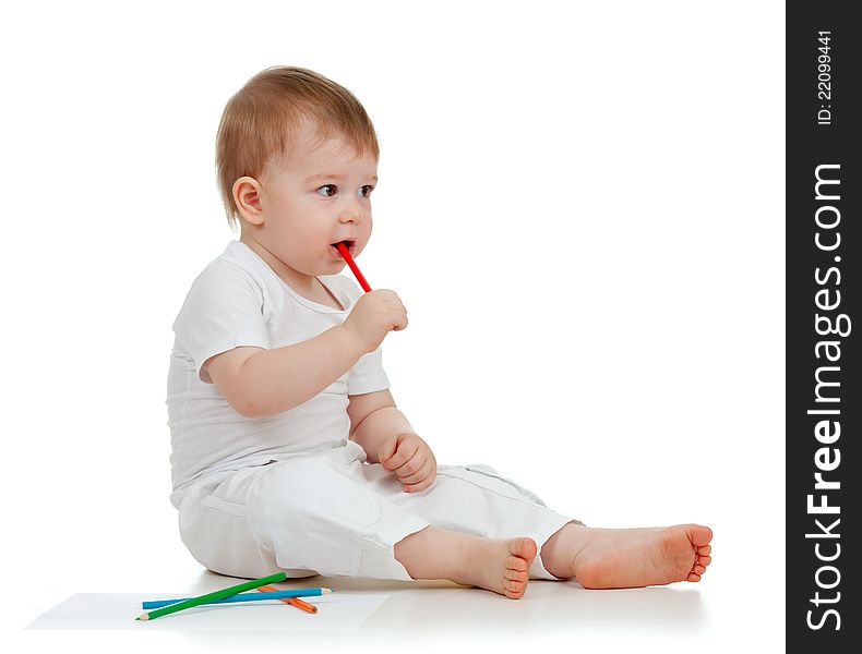 Funny baby boy drawing with color pencils