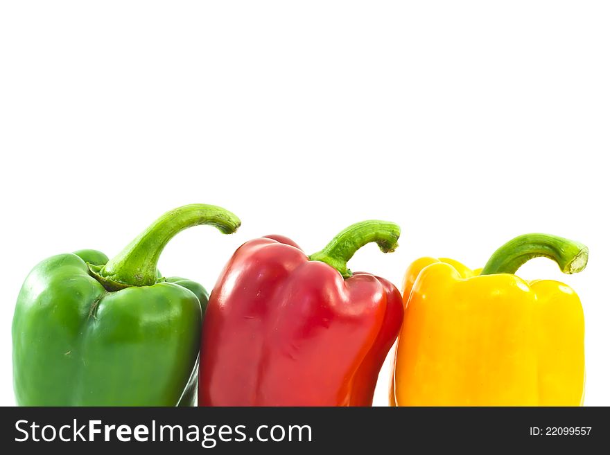 Red, yellow and green bell peppers isolated on the white backgro