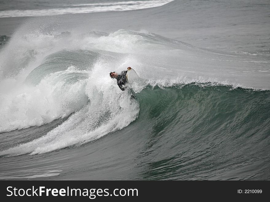 Photo of a bodyboarder on top of the wave
