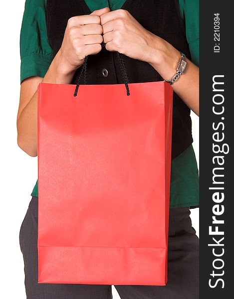 Young adult woman holding a red paper shopping bag in front of her. She is wearing a green shirt, black waist-coat and grey trousers. Image is isolated on a white background. Young adult woman holding a red paper shopping bag in front of her. She is wearing a green shirt, black waist-coat and grey trousers. Image is isolated on a white background