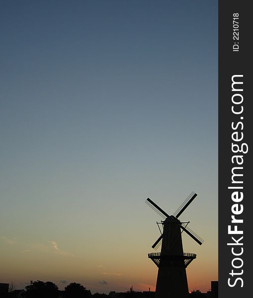 Windmill at the sunset. This is the tallest classic windmill in the world. The windmill is placed at the right side of the picture, so that the rest of the picture is available for text or something else.