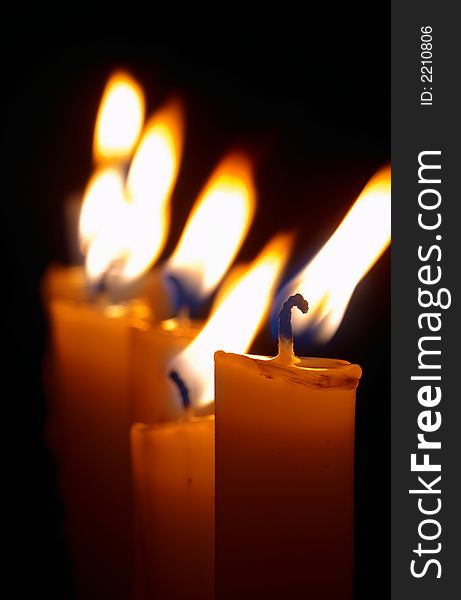 Romantic burning candles on black background