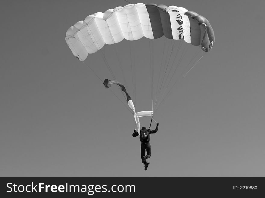 A USAF parachute jumper prepares to land at an airshow.