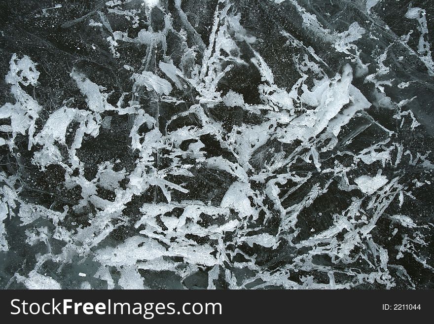 Frosty ornament on ice. Deep frozen water of a river in winter.